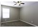 Neutral bedroom features modern ceiling fan, plush carpeting, and bright window with natural light at 786 W Jahns Dr, Casa Grande, AZ 85122