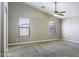 Inviting bedroom features plush carpet, ceiling fan, and two windows with blinds at 786 W Jahns Dr, Casa Grande, AZ 85122