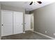 Bedroom features neutral walls, closet, carpet, and natural light from the hall at 786 W Jahns Dr, Casa Grande, AZ 85122