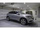 Well-lit garage showcasing a silver car, epoxy floor, and modern overhead lighting at 786 W Jahns Dr, Casa Grande, AZ 85122