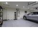 Spacious garage featuring epoxy floors, modern lighting, and ample space for parking, water heater and storage at 786 W Jahns Dr, Casa Grande, AZ 85122
