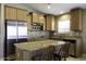 Kitchen island featuring granite countertops, stainless steel appliances, and wooden cabinets at 786 W Jahns Dr, Casa Grande, AZ 85122