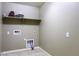 Functional laundry area with tile floors and designated space for washer, dryer and upper shelf at 786 W Jahns Dr, Casa Grande, AZ 85122