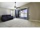 Bright living room with neutral tile flooring, ceiling fan, sliding glass doors, and backyard pool views at 786 W Jahns Dr, Casa Grande, AZ 85122