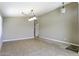 Spacious living room with tile flooring, neutral walls, and a contemporary light fixture at 786 W Jahns Dr, Casa Grande, AZ 85122