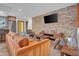 Cozy living room with stylish furniture, a brick accent wall, and a seamless flow to the kitchen at 4644 N 74Th Pl, Scottsdale, AZ 85251