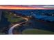 Aerial view of a well-planned community featuring parks, walking paths, and beautifully landscaped homes at dusk at 10331 E Wavelength Ave, Mesa, AZ 85212