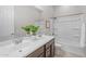 An open bathroom features a shower-tub combo, dual sinks, and a large mirror at 10331 E Wavelength Ave, Mesa, AZ 85212