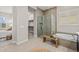 This bathroom has a walk-in shower, soaking tub, and access to walk-in closet for convenience at 10331 E Wavelength Ave, Mesa, AZ 85212