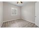 Neutral secondary bedroom with a window, carpeted floors, and a ceiling fan at 10331 E Wavelength Ave, Mesa, AZ 85212
