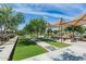Manicured bocce ball court with shade, string lights, and seating, ideal for community enjoyment at 10331 E Wavelength Ave, Mesa, AZ 85212