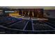 Community entrance with colorful lighting, desert landscaping, and a modern design at 10331 E Wavelength Ave, Mesa, AZ 85212