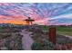 Community garden with a gazebo, seating area, lush landscaping, and a beautiful sunset at 10331 E Wavelength Ave, Mesa, AZ 85212