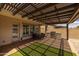 Spacious covered patio offers comfortable seating, a stainless steel grill, and ample space for outdoor entertainment at 10331 E Wavelength Ave, Mesa, AZ 85212