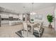 This dining area offers ample seating, stylish lighting, and transitions into the kitchen and Gathering room at 10331 E Wavelength Ave, Mesa, AZ 85212