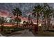 Sculptural Kinetic Point framed by palm trees and a vibrant sunset, adding character to the community at 10331 E Wavelength Ave, Mesa, AZ 85212