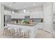 Modern kitchen with white cabinets, center island with seating, and stainless steel appliances at 10331 E Wavelength Ave, Mesa, AZ 85212