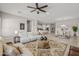 Open-concept living room with tile flooring, ceiling fan, and stylish contemporary furniture at 10331 E Wavelength Ave, Mesa, AZ 85212