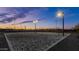 Well-lit sand volleyball court ready for evening games with safety nets and stadium lighting at 10331 E Wavelength Ave, Mesa, AZ 85212