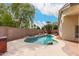 Backyard pool surrounded by desert landscaping, a hot tub, and a privacy wall at 10209 W Jessie Ln, Peoria, AZ 85383