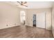 Bright bedroom with wood floors, closet, and access to the ensuite bathroom at 10209 W Jessie Ln, Peoria, AZ 85383