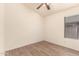Cozy bedroom featuring wood floors, ceiling fan, and a window at 10209 W Jessie Ln, Peoria, AZ 85383