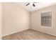 Beige bedroom showcases wood-look floors, white baseboards and trim, and a window at 10209 W Jessie Ln, Peoria, AZ 85383