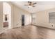 Spacious bedroom with wood floors, ceiling fan, natural light, closet, and access to ensuite bathroom at 10209 W Jessie Ln, Peoria, AZ 85383