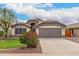 Inviting front exterior of a single-story home with a well-manicured lawn and gray garage door at 10209 W Jessie Ln, Peoria, AZ 85383