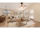 Inviting living room with vaulted ceiling, neutral furnishings, and warm wood-look flooring at 10209 W Jessie Ln, Peoria, AZ 85383