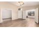 Spacious living room featuring neutral walls, wood-look flooring, and an open layout at 10209 W Jessie Ln, Peoria, AZ 85383