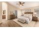 Serene bedroom with a wooden bed frame, dresser, and views of the bathroom at 10209 W Jessie Ln, Peoria, AZ 85383