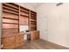 Office with wood-look floors, built-in desk and shelving, and white trim at 10209 W Jessie Ln, Peoria, AZ 85383