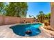 Backyard pool surrounded by mature landscaping with a brick privacy wall and concrete pool decking at 10209 W Jessie Ln, Peoria, AZ 85383