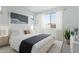 Serene bedroom with soft lighting, large window, and a comfortable bed complemented by stylish décor and neutral tones at 16173 S 181St Ave, Goodyear, AZ 85338