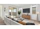 Inviting living room with a plush sofa, sleek entertainment center, and sliding glass doors for indoor/outdoor living at 16173 S 181St Ave, Goodyear, AZ 85338