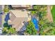 An aerial view of a desert home with a large tile roof, backyard pool, patio, and palm trees at 760 N Ithica St, Gilbert, AZ 85233