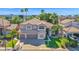 An aerial view of the beautiful two-story home, showcasing its lush landscaping, tile roof, and convenient three-car garage at 760 N Ithica St, Gilbert, AZ 85233