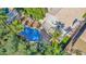 A bird's-eye view showcases the backyard pool, patio, and palm trees surrounded by green landscaping at 760 N Ithica St, Gilbert, AZ 85233