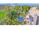 The backyard oasis features a blue pool, mature trees and landscaping, and a covered patio area at 760 N Ithica St, Gilbert, AZ 85233