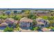 An aerial view shows a two-story home, three-car garage, large front lawn and neighborhood golf course at 760 N Ithica St, Gilbert, AZ 85233