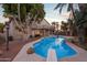 Inviting backyard pool with diving board, mature landscaping, and a spacious patio perfect for outdoor entertaining at 760 N Ithica St, Gilbert, AZ 85233