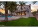 A lush lawn with a view of the patio, second story and pool at 760 N Ithica St, Gilbert, AZ 85233