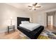 Comfortable bedroom showcasing a large bed, ceiling fan and carpet with neutral colors at 760 N Ithica St, Gilbert, AZ 85233