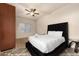 Bedroom featuring a plush rug, a large bed with a black headboard, and dark wooden cabinets at 760 N Ithica St, Gilbert, AZ 85233