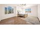 Well-lit bedroom showcasing large windows, wood flooring, ceiling fan and neutral colors at 760 N Ithica St, Gilbert, AZ 85233