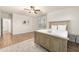 Spacious bedroom featuring wood-look flooring, ceiling fan, and ample natural light at 760 N Ithica St, Gilbert, AZ 85233