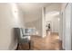 Second floor hallway with hardwood floors, neutral paint, and an accent chair at 760 N Ithica St, Gilbert, AZ 85233