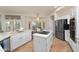 Bright kitchen with stainless appliances, white cabinets, island and breakfast nook at 760 N Ithica St, Gilbert, AZ 85233