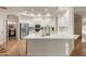 Open concept kitchen with quartz counters, stainless appliances, and white cabinets at 760 N Ithica St, Gilbert, AZ 85233